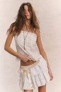 Cotton cami top in bright white with lace border and scalloped hem detail.