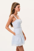 Light blue cotton mini dress side view with thin straps, button-front tiers and lace-trim hem