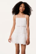Optic white tween mini dress with spaghetti straps, tiered panels, and lace trim
