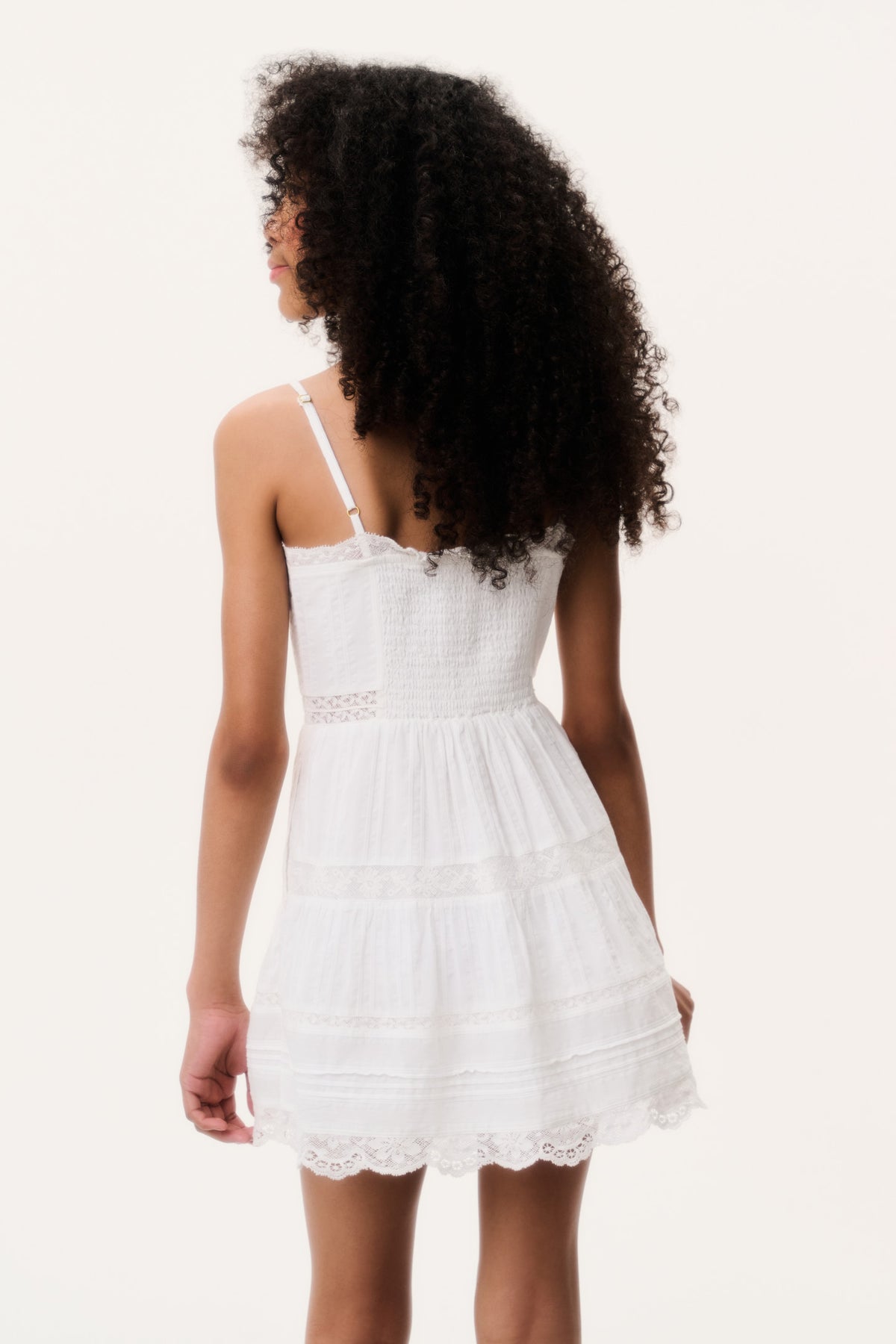 Optic white tween mini dress back view with spaghetti straps and tiered skirt