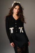 Midnight black bow cardigan with V-neck, button front, and white ribbon applique