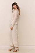 Cream lace-trimmed balloon pants with gathered ruffle cuffs and relaxed wide legs