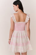 Pink tiered mini dress with square neckline and ruffled shoulder straps, back view