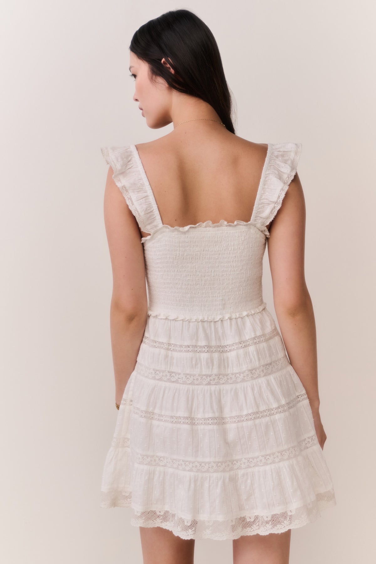 Back-view lace-trimmed cotton mini dress with ruffled straps and tiered skirt