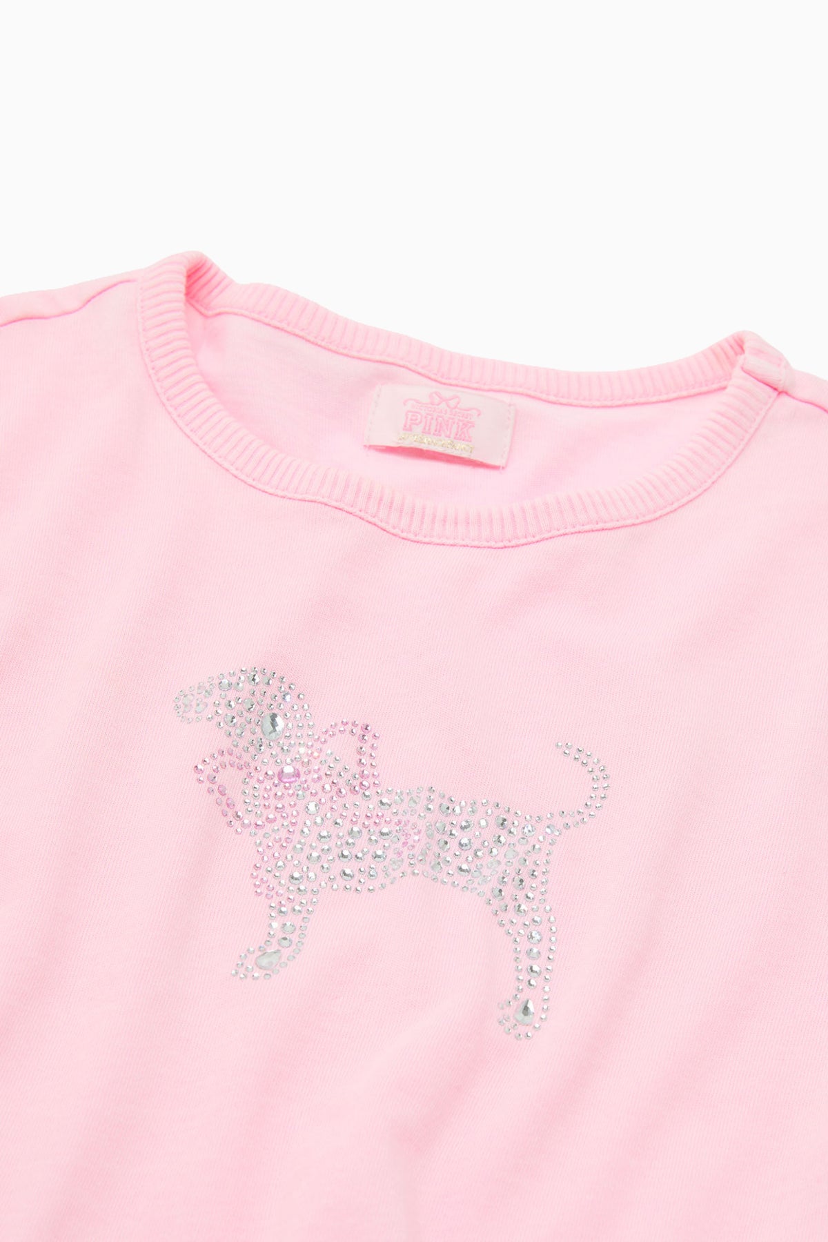 Pink cotton baby tee close-up, ribbed crew neck and sequined dog graphic
