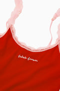Red cotton cami with pink lace trim and script logo on the front