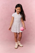 White eyelet active dress with front button placket and gathered flared skirt
