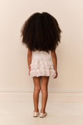 Girls pink back view tiered ruffle twirl skirt with pastel bow pattern