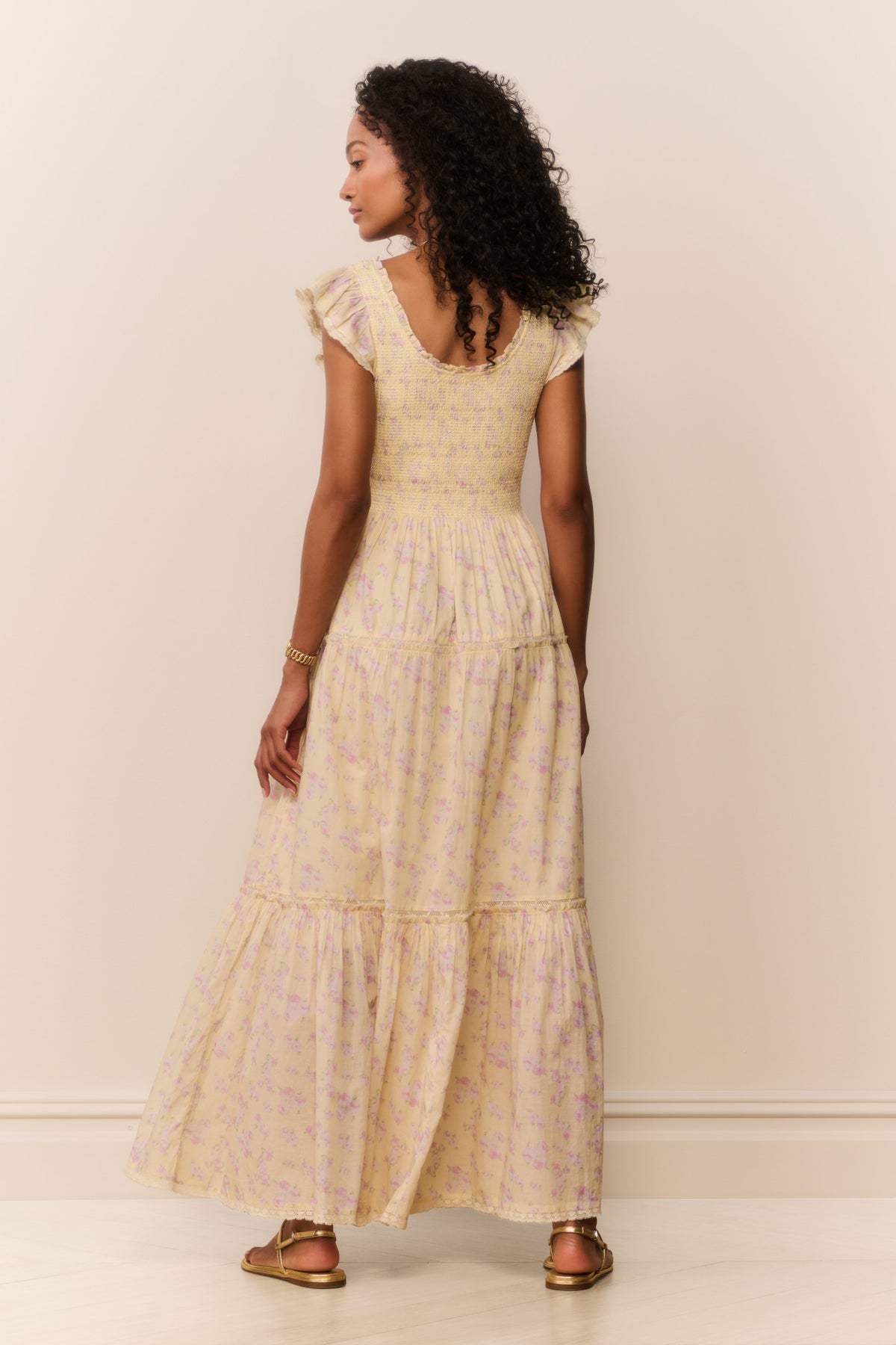 Back view of lemon floral tiered maxi dress with flutter sleeves