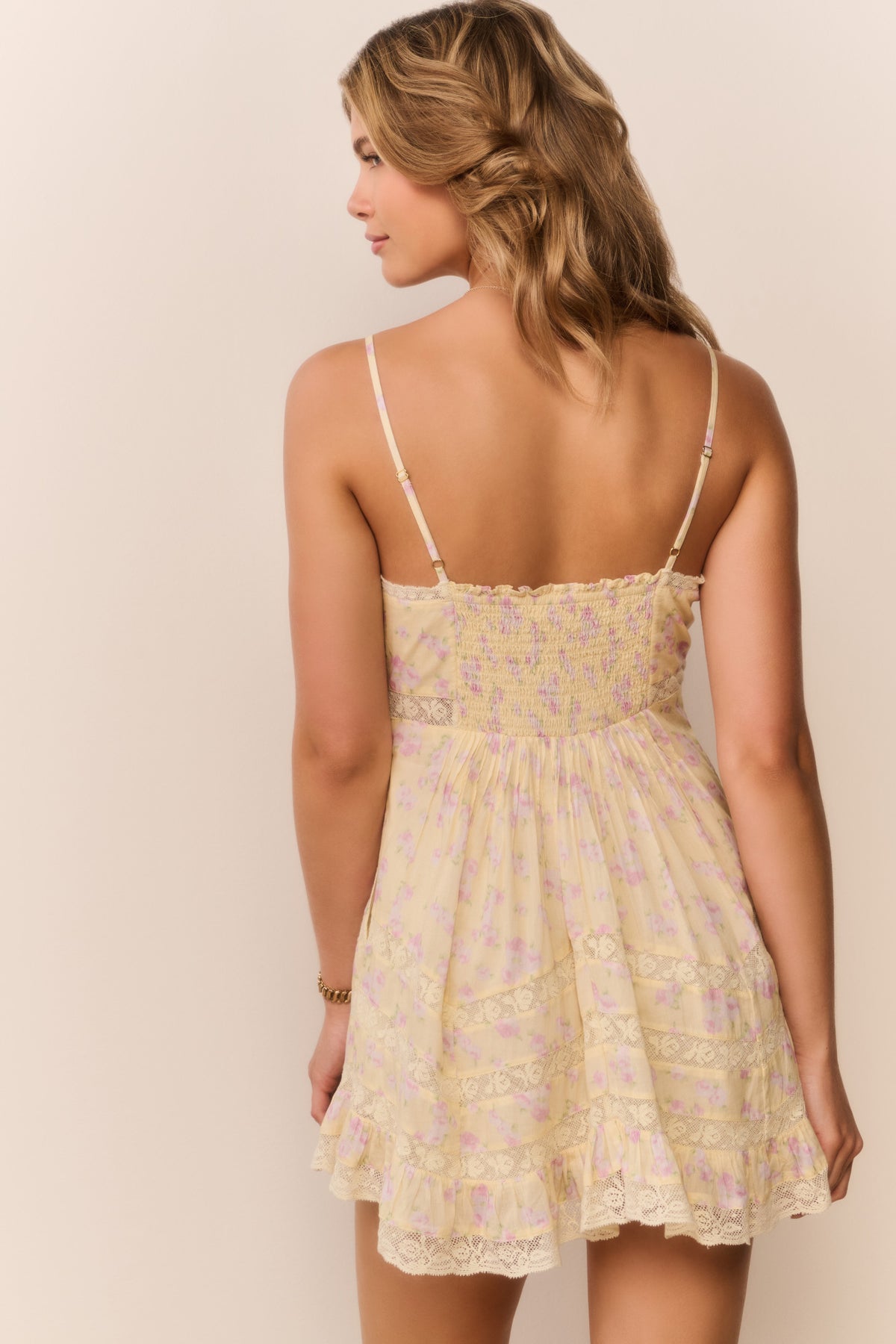 Floral mini dress, open-back style look with spaghetti straps and tiered skirt