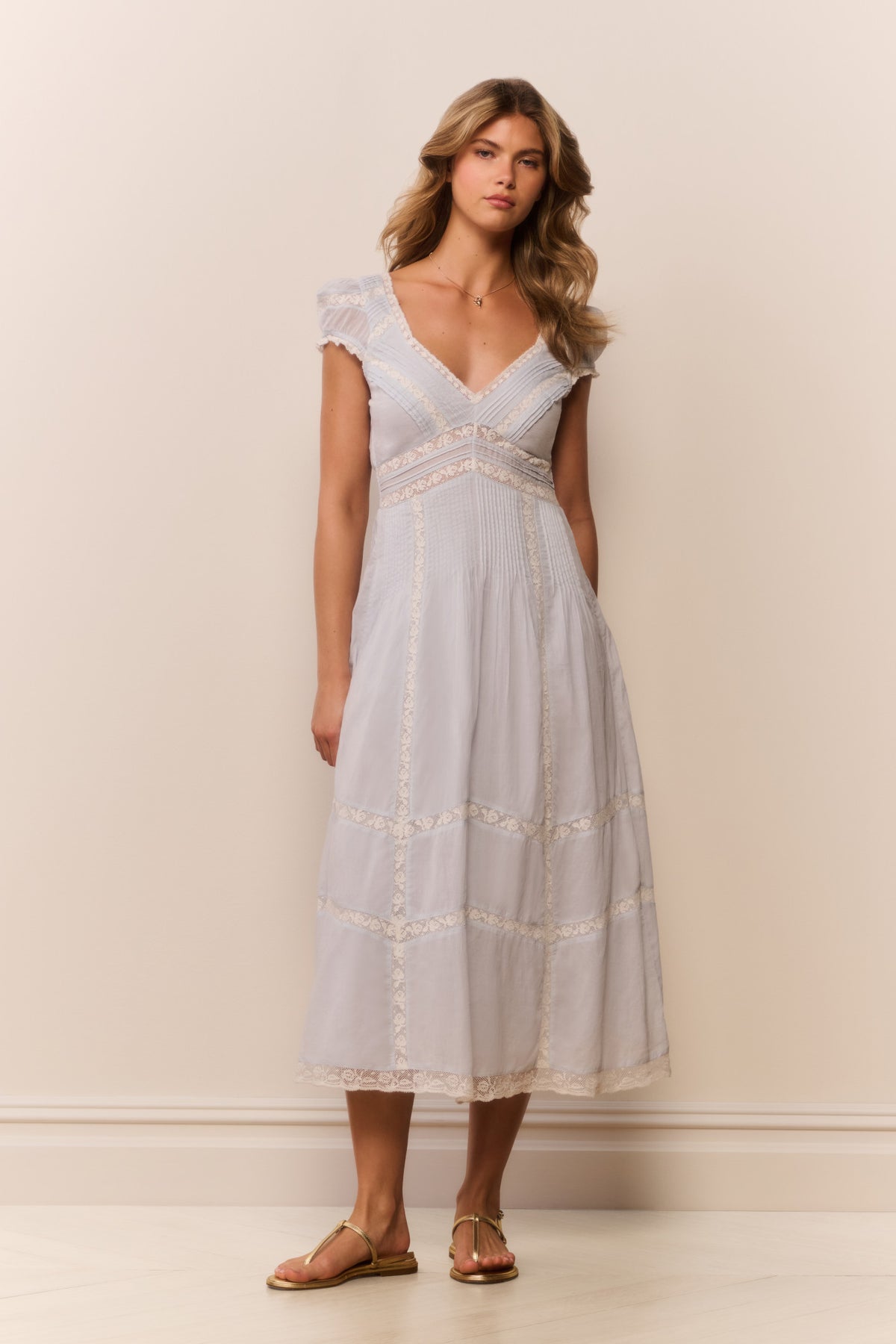 Light blue midi dress with V-neckline, embroidered yoke, and tiered skirt with lace trim