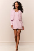 Pink lace-trimmed tweed jacket worn with matching mini dress, front view