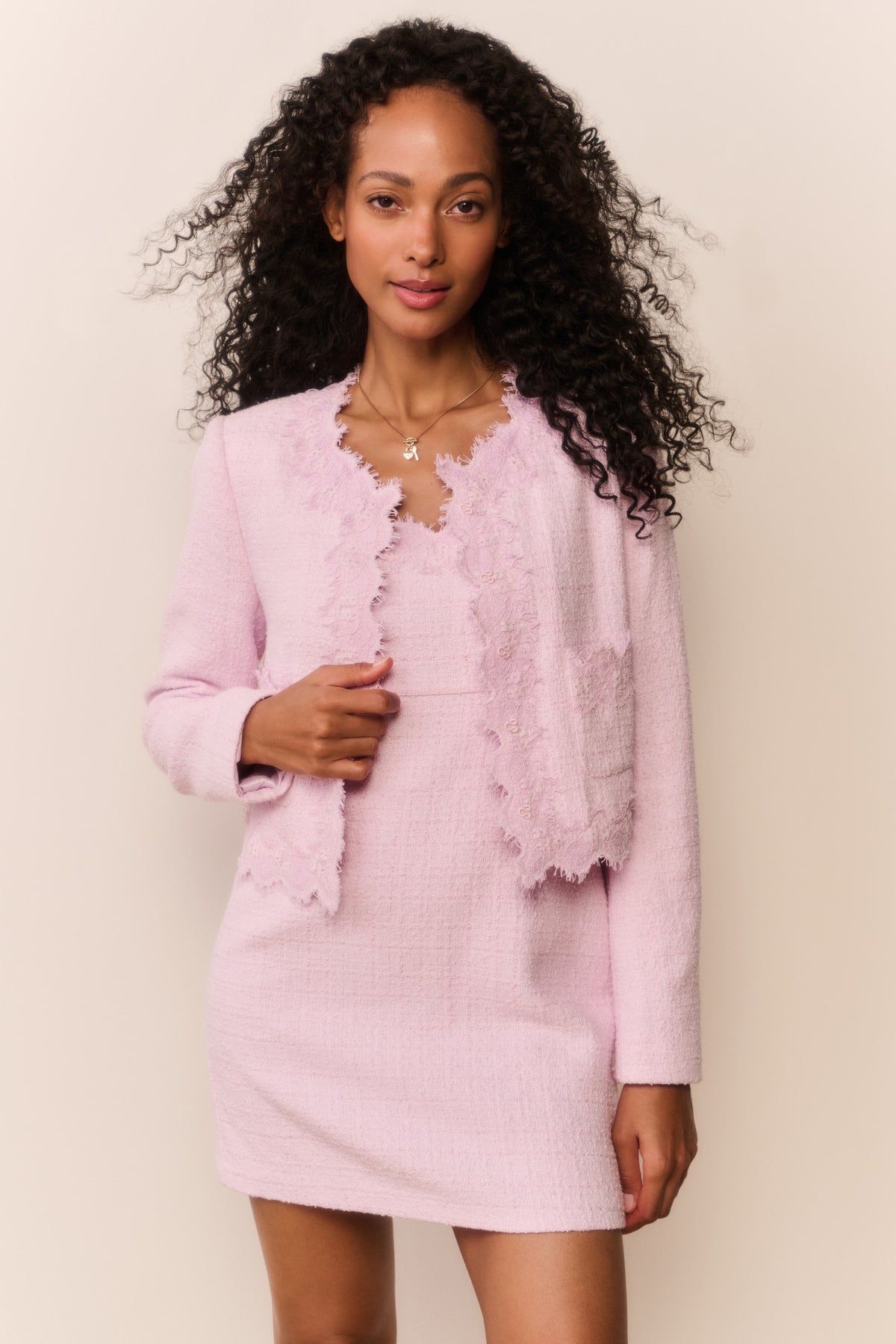 Pink lace-trimmed tweed jacket with open scalloped front and long sleeves