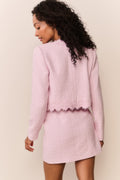 Pink lace-trimmed tweed jacket with scalloped hem detail, back view