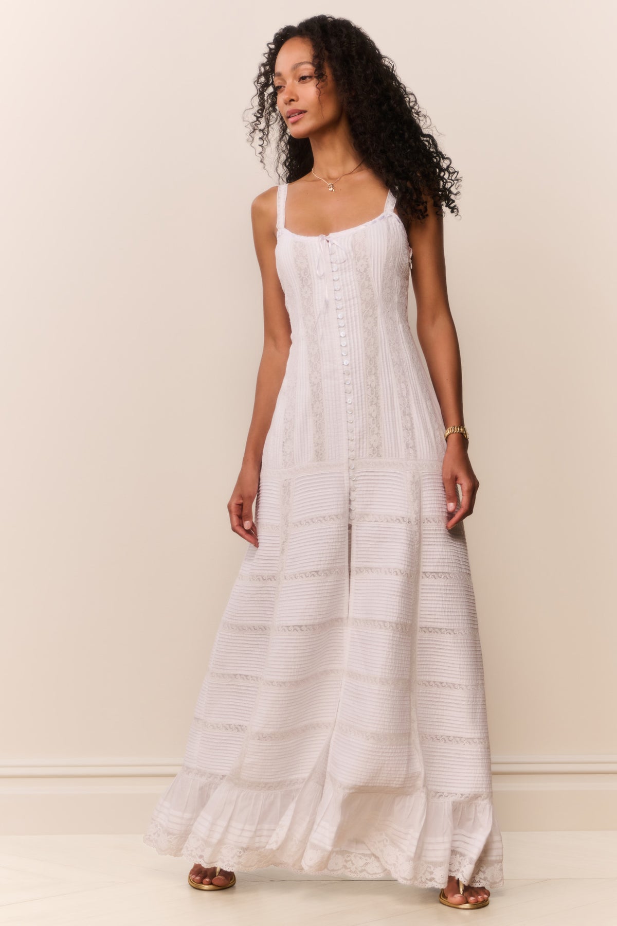 White cotton Victorian maxi dress standing view with lace texture and tiered skirt