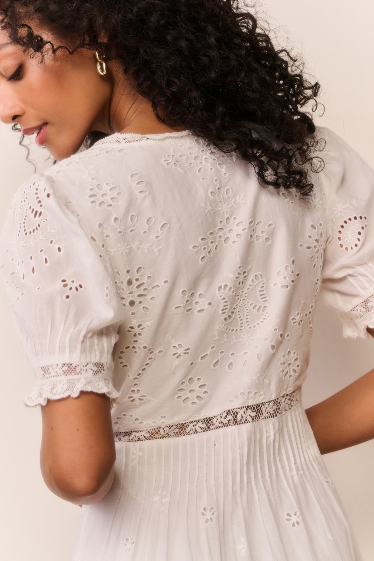 White cotton eyelet midi dress, back view with lace panels and puff sleeves