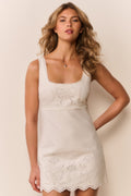 Ivory sleeveless eyelet mini dress with embroidered floral details and scalloped hem