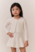 Girls cream pointelle knit cardigan with button front and decorative vertical rows