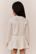 Girls cream pointelle knit cardigan, back view with textured vertical stripe pattern