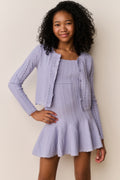 Lavender pointelle knit cardigan worn open, long sleeves, textured knit detail.