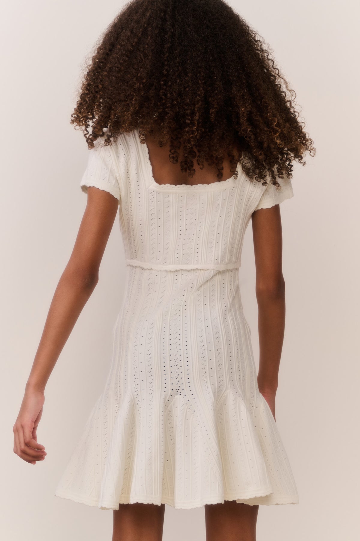 Tween pointelle stretch dress in white, back view with flared skirt