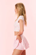 Pink printed active skort, side view with pleats and flared tennis hem
