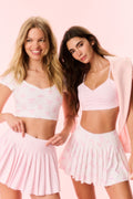 Pink printed active skort with pleated skirt overlay and built-in shorts