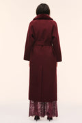 Back view of dark merlot long wool coat with faux fur collar and tied waist belt.