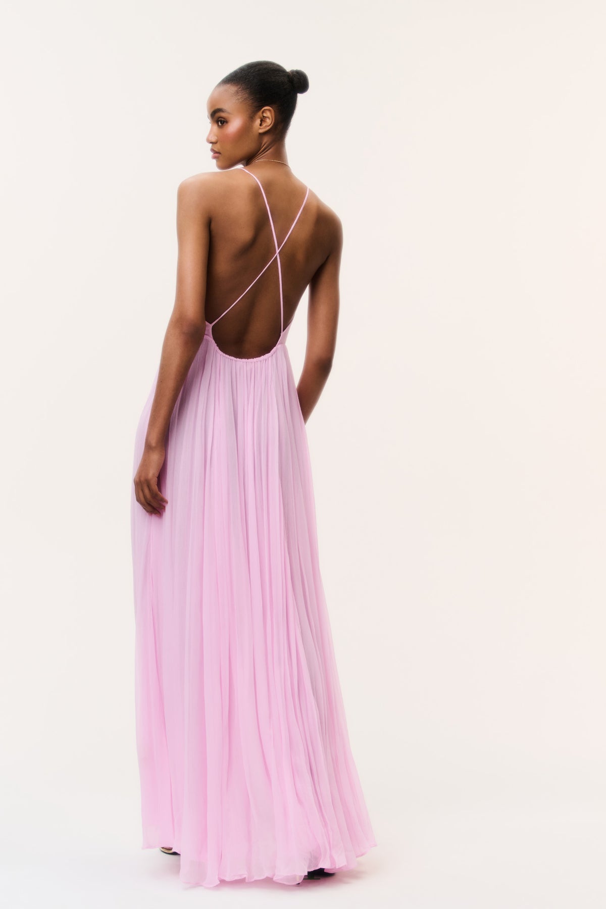 Light pink chiffon maxi dress shown from back, with open back and spaghetti straps