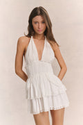 White halter mini dress with open V neckline and tiered ruffle skirt