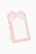 Pink floral decorative frame with satin bow and open photo window