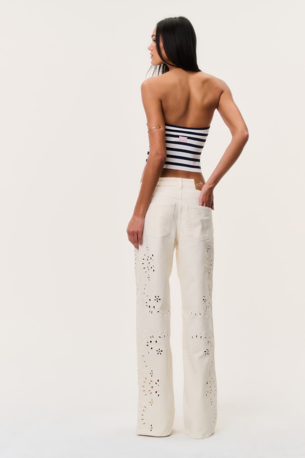 Ivory eyelet floral cutout wide-leg jeans, back view with button fly