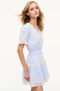 Light blue mini cotton dress with lace V neckline, puff sleeves, gathered waist, tiered skirt