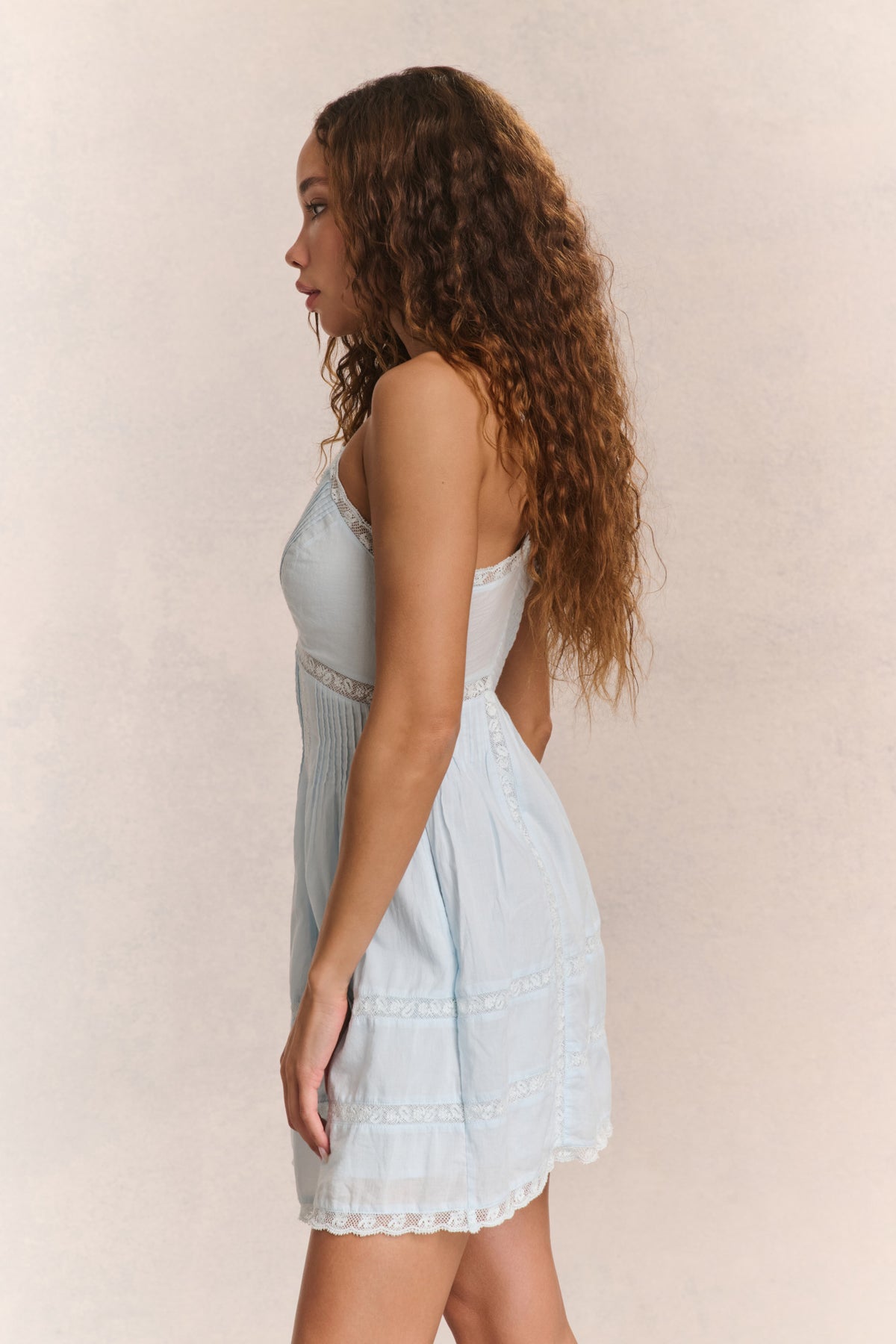 Light blue cotton mini dress, back view with spaghetti straps and tiered skirt