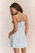 White cotton mini dress back view with spaghetti straps and tiered skirt