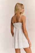 White cotton mini dress back view with spaghetti straps and lace trim