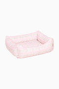 Light pink printed dog bed with cushioned walls and open center