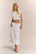 White tiered midi skirt with embroidered bands and ruffle hem
