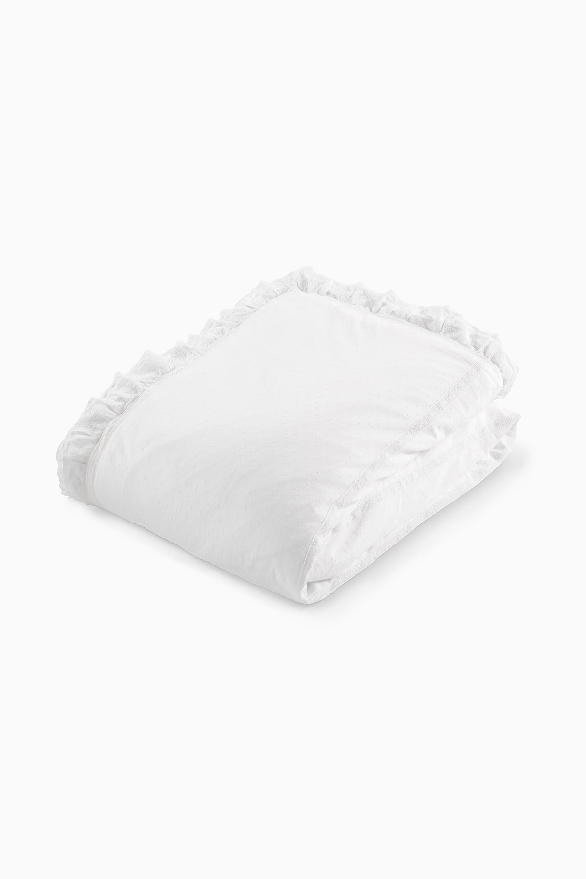 Folded white duvet with ruffled trim and decorative edge stitching