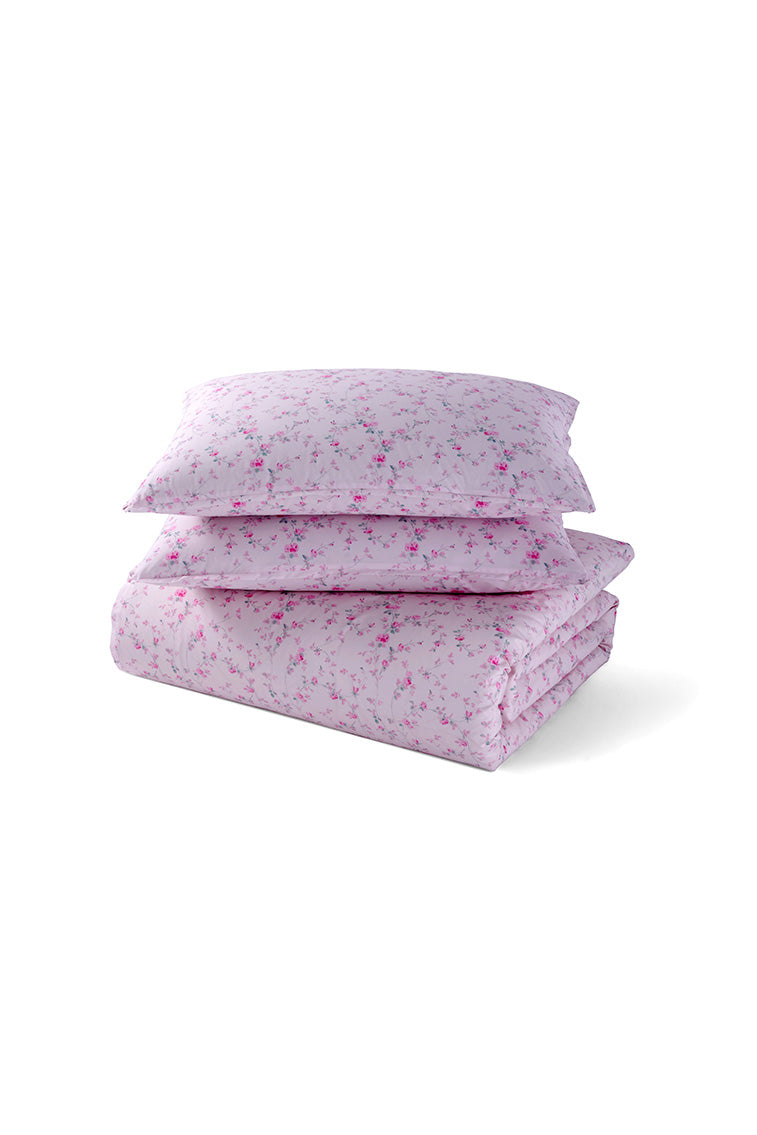 Pink floral duvet cover set with matching shams, folded and stacked