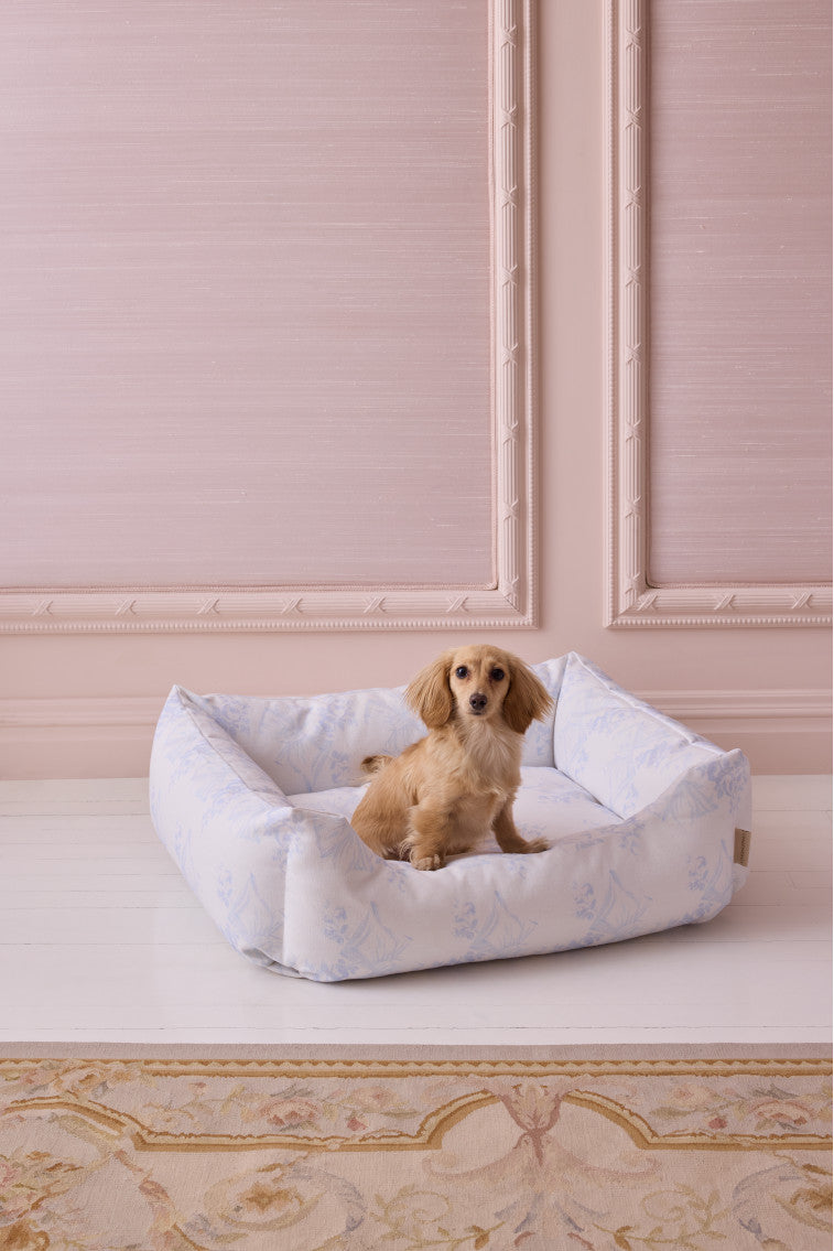 Light blue printed dog bed with cushioned bolstered sides