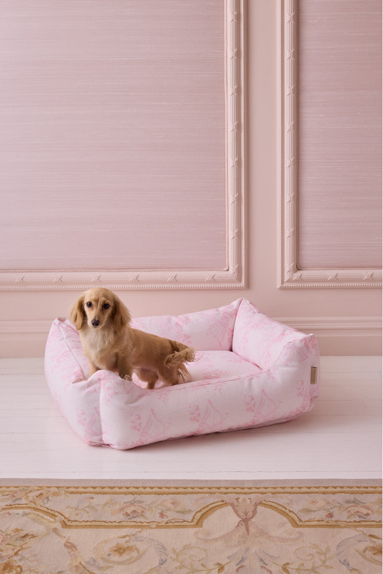 Pink printed dog bed with bolstered edges and soft inner cushion
