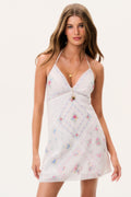 White mini dress with embroidered patchwork, spaghetti straps, and lace hem