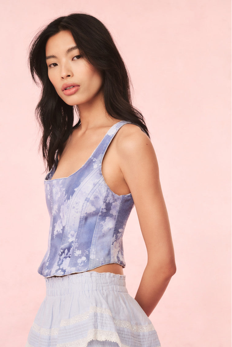 Floral denim bustier top in blue with spaghetti straps and center-front zipper seam