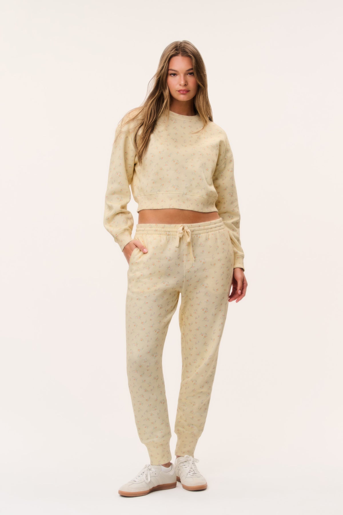 Ditsy floral cream sweatpants with elastic drawstring waist and relaxed tapered legs