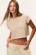 Cream ditsy floral cropped tee with short sleeves and crew neckline, front view