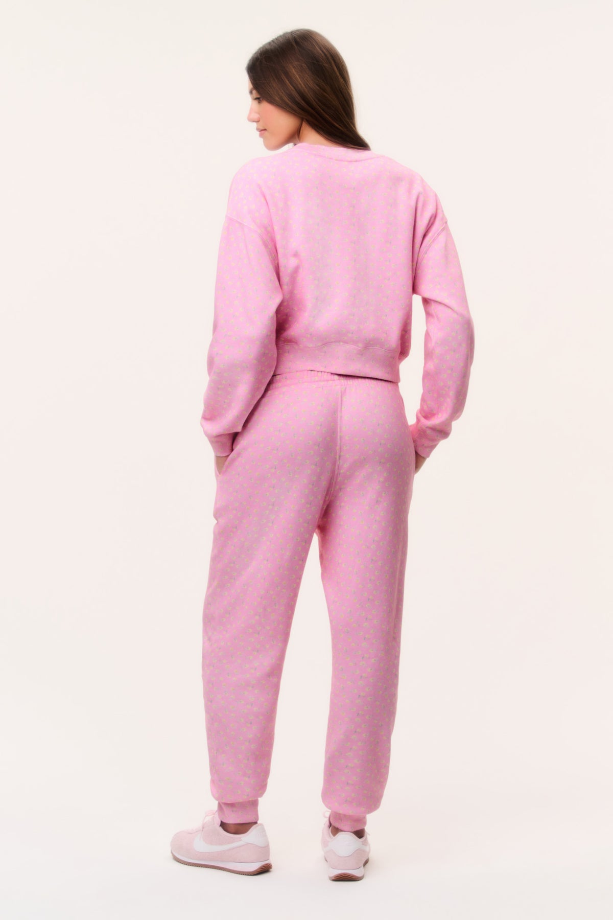 Pink ditsy floral sweatpants rear view with elastic waistband and tapered legs
