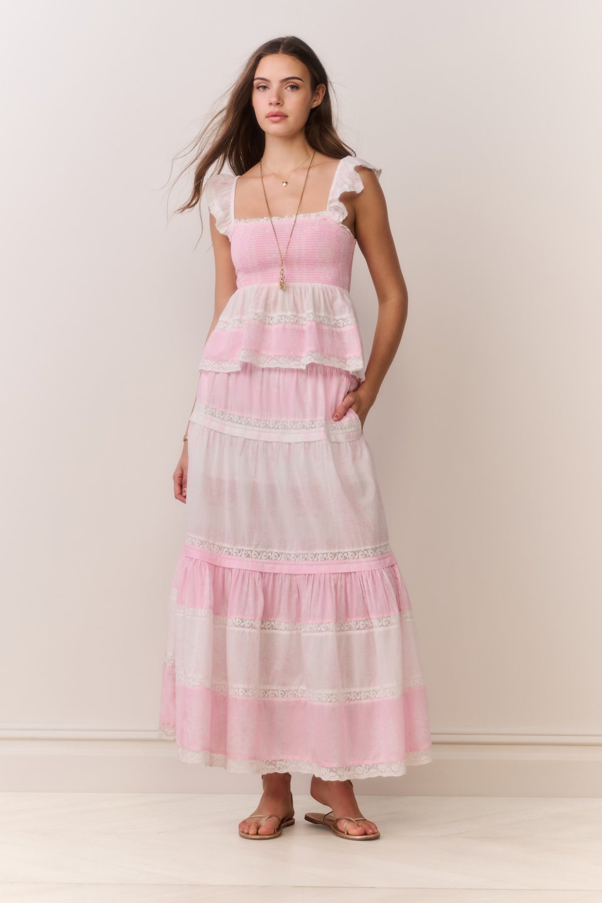 Pink tiered maxi skirt with ruffled tiers and mixed print paneling