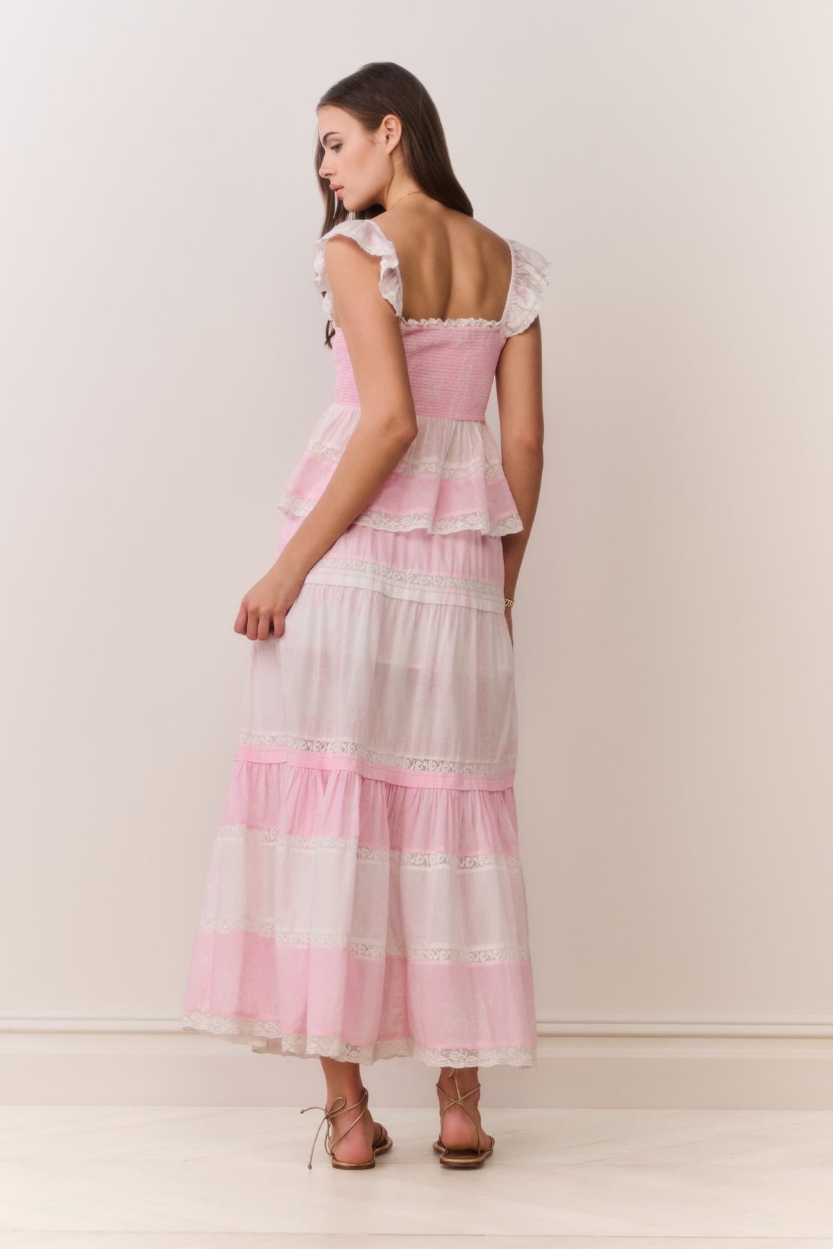 Tiered pink maxi skirt with ruffled layers and mixed print hem