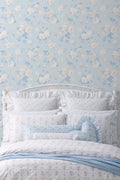 Whisper blue peel-and-stick wallpaper on wall with pale blue floral motif
